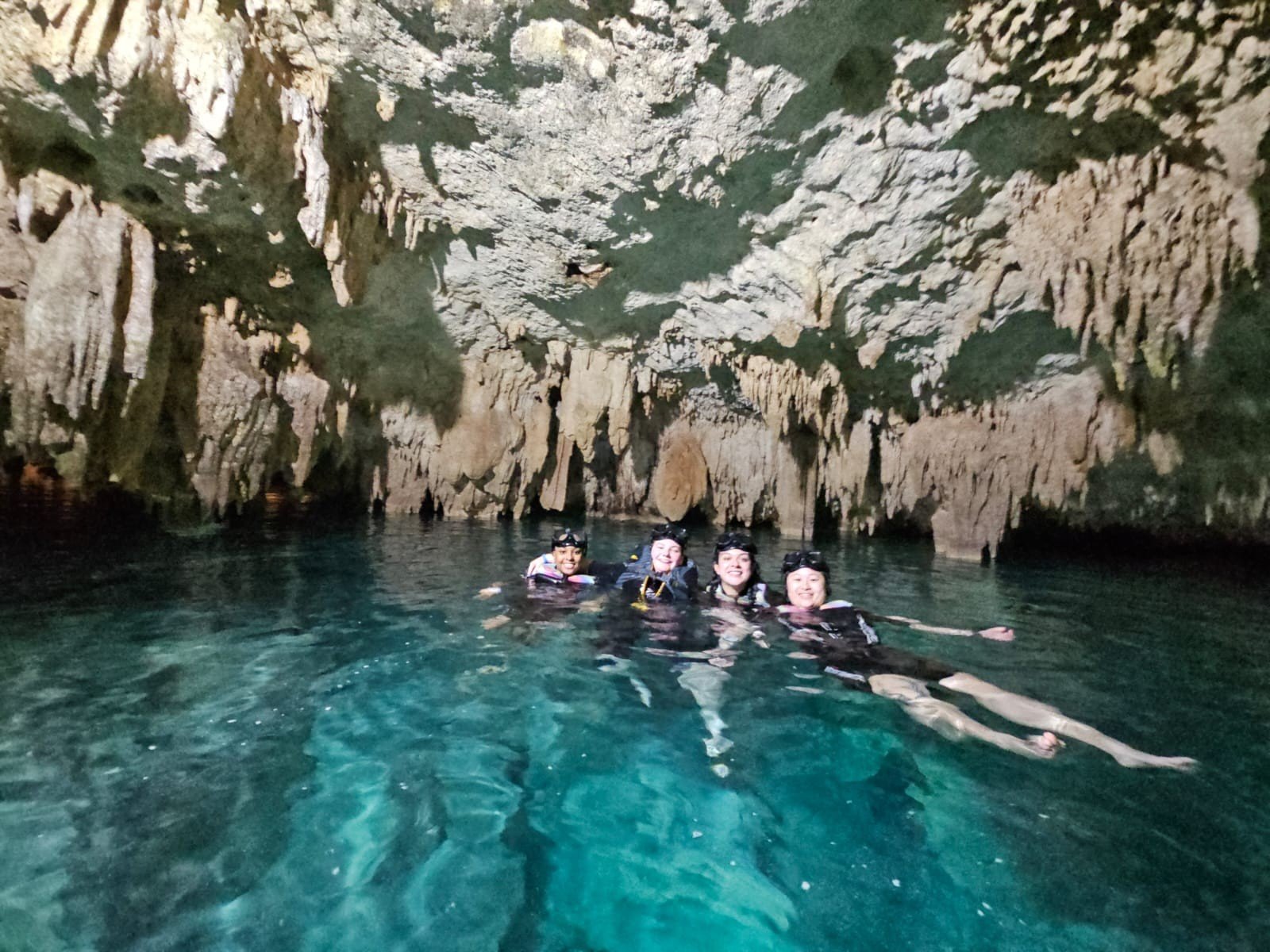Women swimming in a cenote near Playa del Carmen, Mexico, on a Greether experience